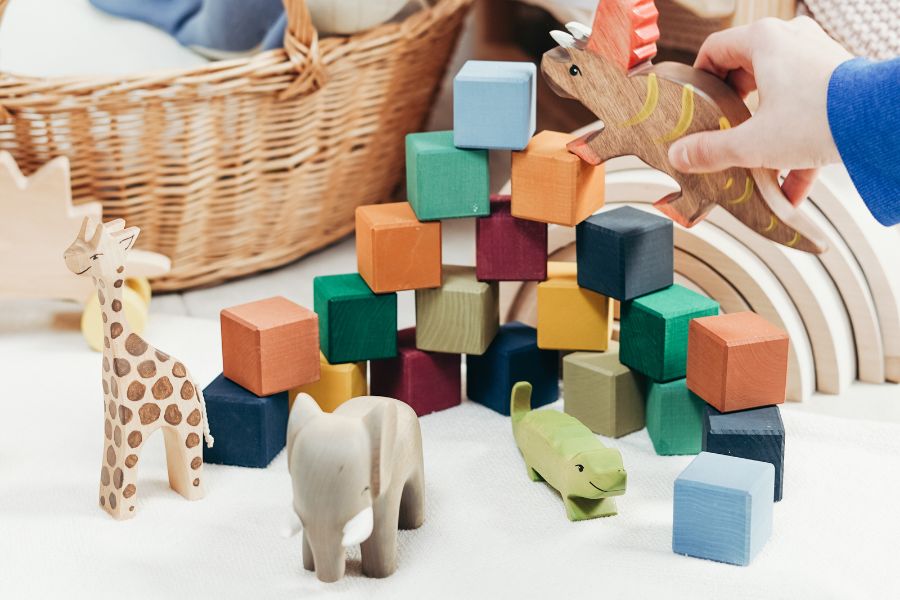 Handmade wooden toys of animals and colorful blocks