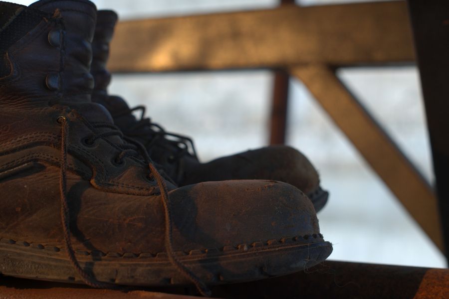 Work boots on rusted metal rack