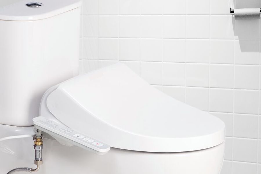 Toilet with bidet attachment in the bathroom