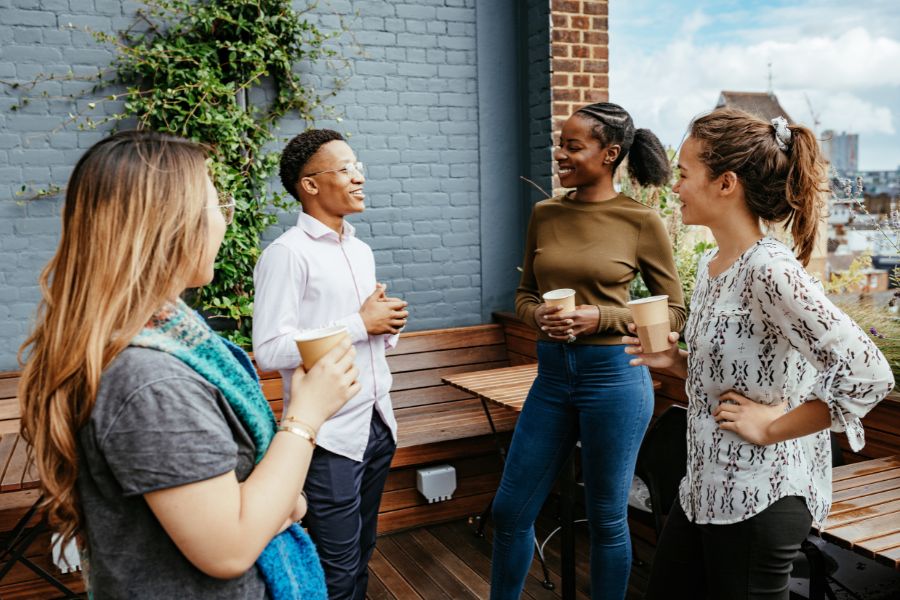 Group of millennials drinking coffee and chatting