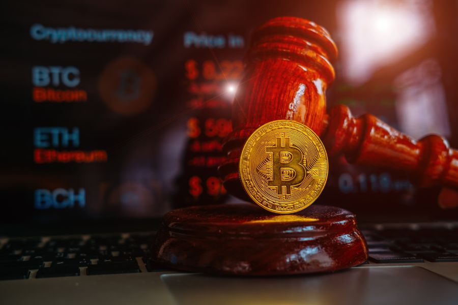 Law gavel and bitcoins on wooden desk