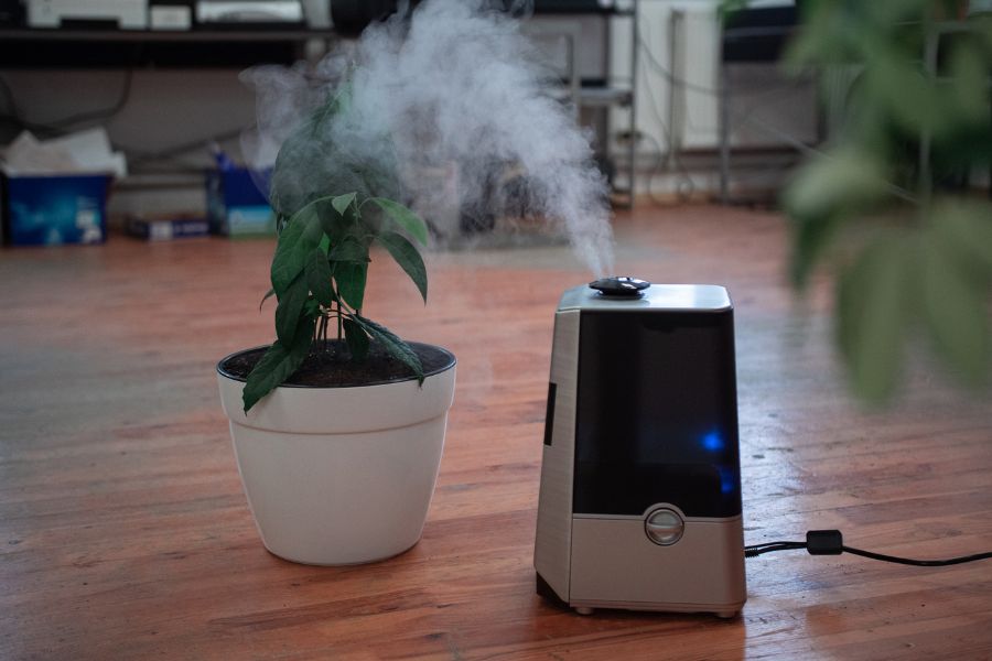 Turned-on warm mist humidifier on the floor