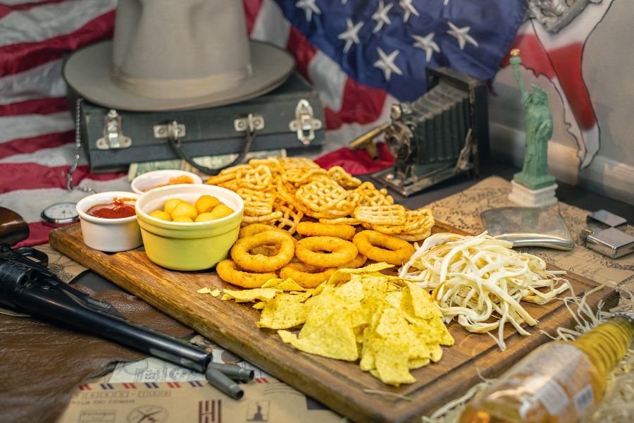 Different American snacks on wooden boards with American symbols