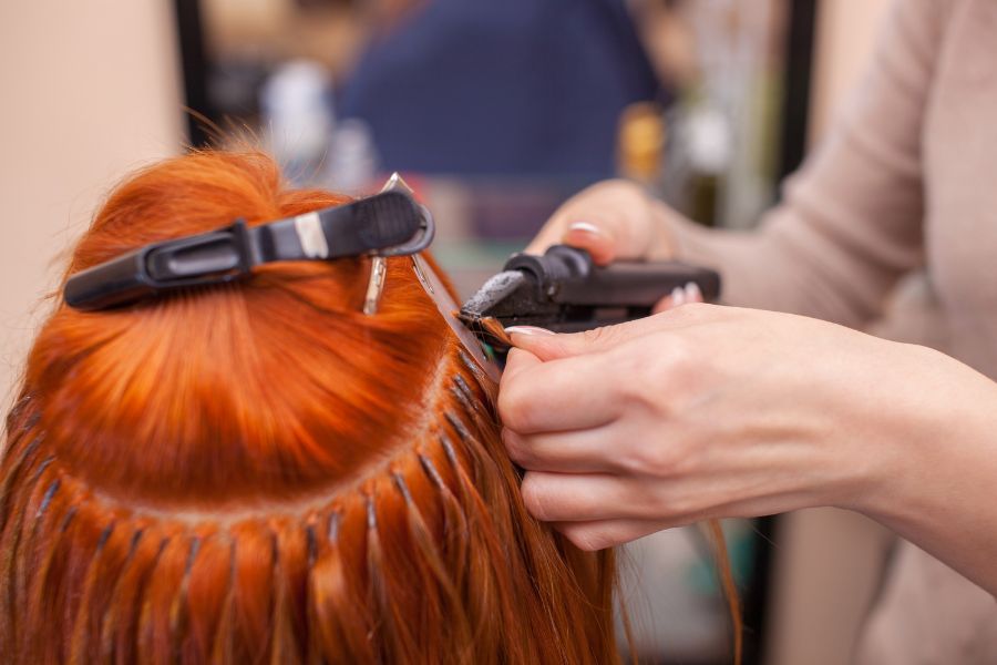 Hair extensions being applied in professional salon