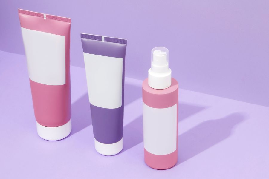 Makeup samples with white label on purple background