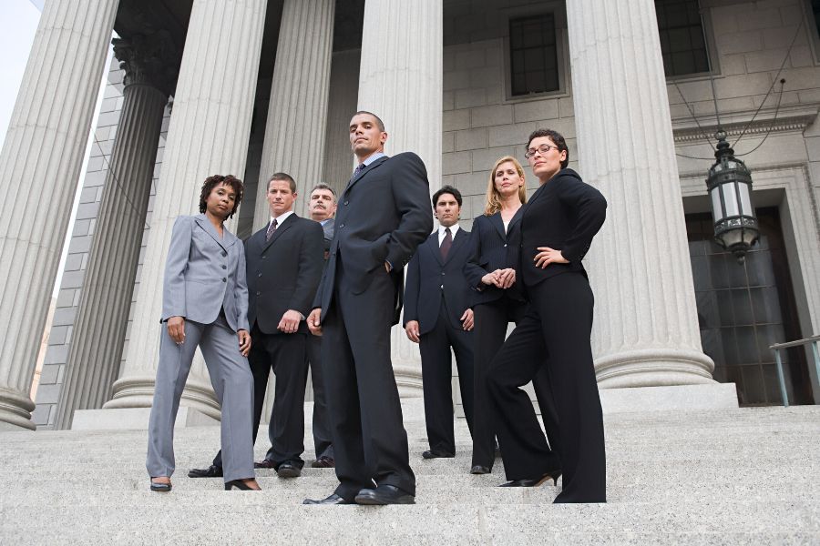 Group of lawyers posing in front of the courthouse